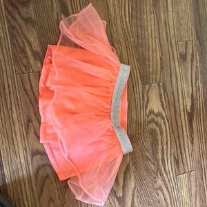 Orange neon tutu skirt with shorts connected underneath. Super cute